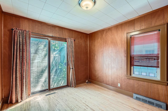 2653 Pierce St NE, Minneapolis, MN 55418 - spare room featuring healthy amount of natural light, wood finished floors, and wood walls