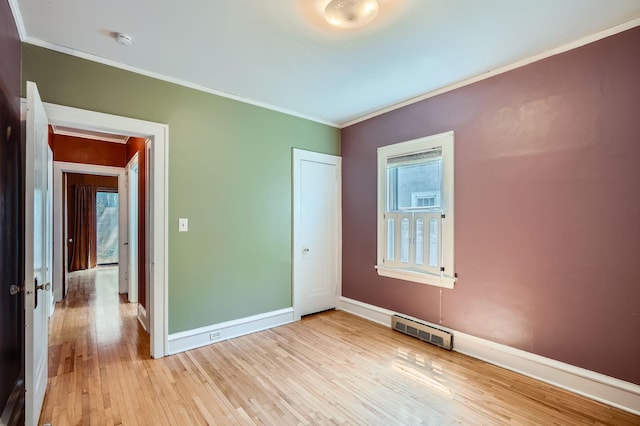 2653 Pierce St NE, Minneapolis, MN 55418 - spare room with light wood-type flooring, ornamental molding, a smoke detector, and baseboards