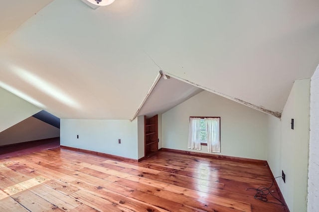 2653 Pierce St NE, Minneapolis, MN 55418 - additional living space featuring light wood-style flooring, vaulted ceiling, and baseboards