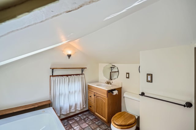 2653 Pierce St NE, Minneapolis, MN 55418 - full bathroom with vaulted ceiling, toilet, vanity, and a bathtub