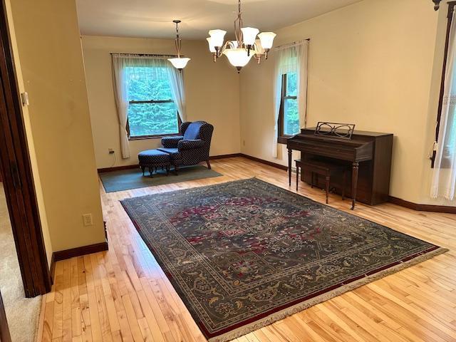 77729 330th St, Prior Twp, MN 56278 - sitting room with wood-type flooring, a chandelier, and baseboards