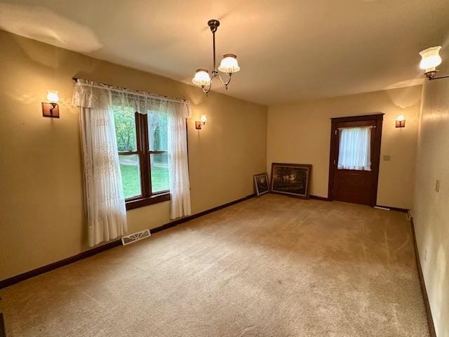 77729 330th St, Prior Twp, MN 56278 - unfurnished living room featuring a chandelier, carpet flooring, and baseboards
