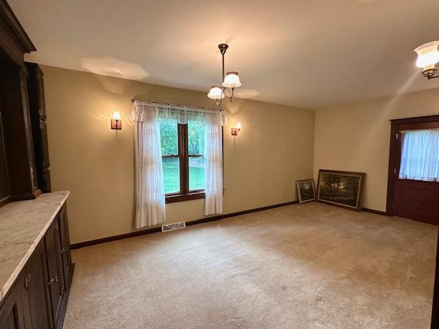 77729 330th St, Prior Twp, MN 56278 - unfurnished living room with a chandelier, light carpet, and baseboards