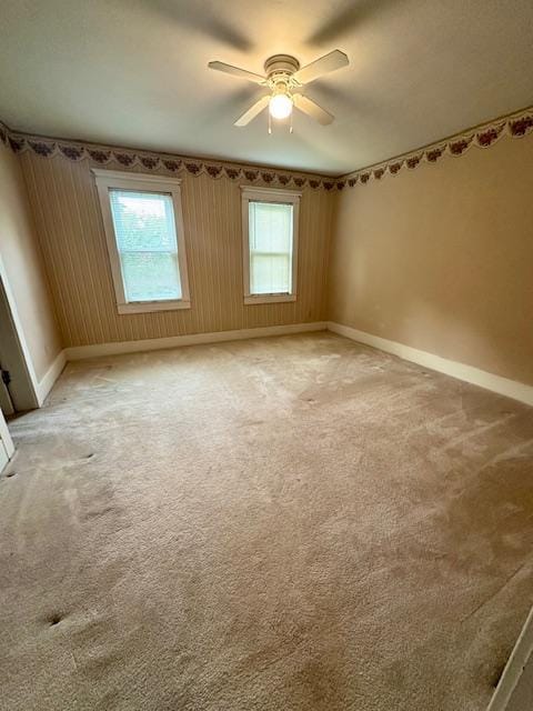 77729 330th St, Prior Twp, MN 56278 - spare room featuring baseboards, a ceiling fan, and light colored carpet