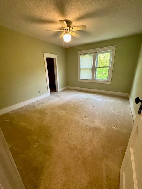77729 330th St, Prior Twp, MN 56278 - empty room featuring a textured ceiling, light colored carpet, ceiling fan, and baseboards