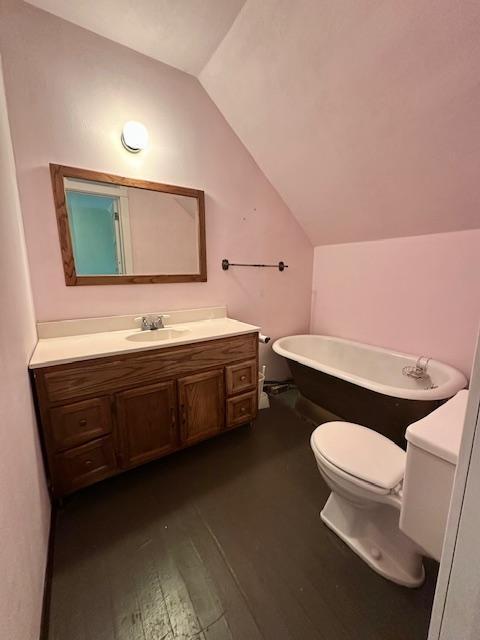 77729 330th St, Prior Twp, MN 56278 - full bath featuring lofted ceiling, a freestanding bath, vanity, wood finished floors, and toilet