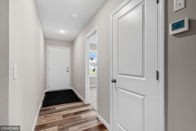 1009 2nd St NW, Delano, MN 55328 - entryway featuring wood finished floors, baseboards, and recessed lighting