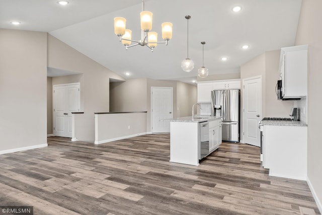 1009 2nd St NW, Delano, MN 55328 - kitchen featuring appliances with stainless steel finishes, a sink, white cabinetry, baseboards, and a center island with sink