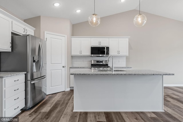1009 2nd St NW, Delano, MN 55328 - kitchen with appliances with stainless steel finishes, vaulted ceiling, tasteful backsplash, white cabinetry, and dark wood-type flooring