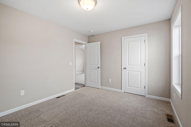 1009 2nd St NW, Delano, MN 55328 - unfurnished bedroom with carpet and baseboards
