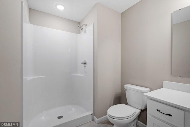 1009 2nd St NW, Delano, MN 55328 - full bath featuring vanity, toilet, a shower, and baseboards