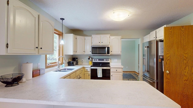 5121 Cameron Dr NW, Cascade Twp, MN 55901 - kitchen featuring appliances with stainless steel finishes, a sink, light countertops, a peninsula, and decorative light fixtures