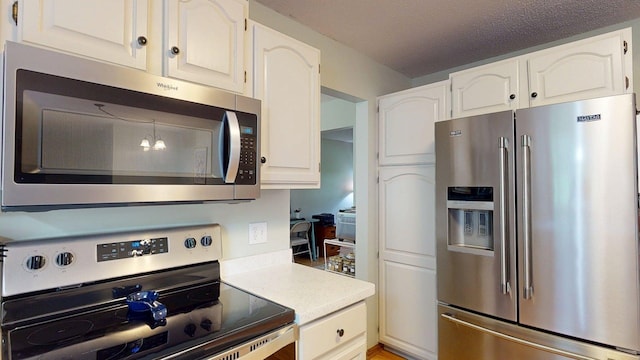 5121 Cameron Dr NW, Cascade Twp, MN 55901 - kitchen featuring stainless steel appliances, light countertops, and white cabinetry