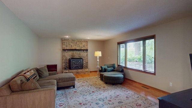 5121 Cameron Dr NW, Cascade Twp, MN 55901 - living room featuring wood finished floors and a brick fireplace