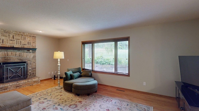 5121 Cameron Dr NW, Cascade Twp, MN 55901 - living area with wood finished floors and a brick fireplace