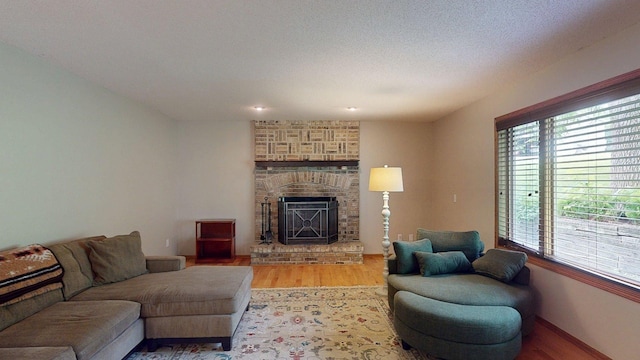 5121 Cameron Dr NW, Cascade Twp, MN 55901 - living room with a brick fireplace, wood finished floors, and baseboards