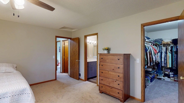 5121 Cameron Dr NW, Cascade Twp, MN 55901 - bedroom with a walk in closet, light carpet, a closet, baseboards, and ensuite bath