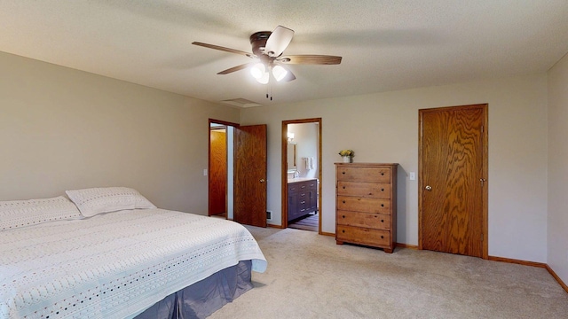 5121 Cameron Dr NW, Cascade Twp, MN 55901 - bedroom with light colored carpet, baseboards, ensuite bathroom, and a ceiling fan