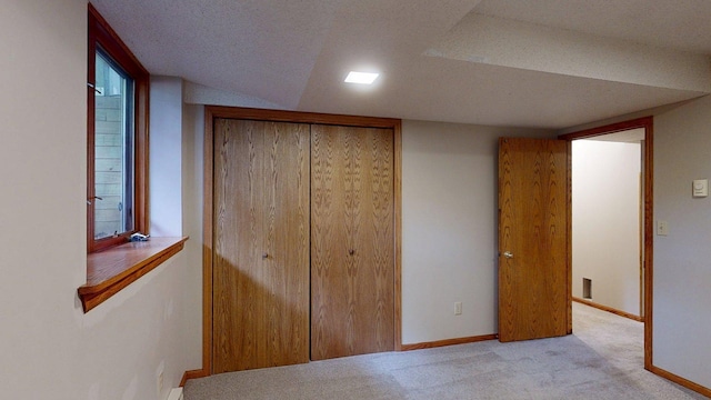 5121 Cameron Dr NW, Cascade Twp, MN 55901 - unfurnished bedroom featuring a closet, carpet floors, baseboards, and a textured ceiling