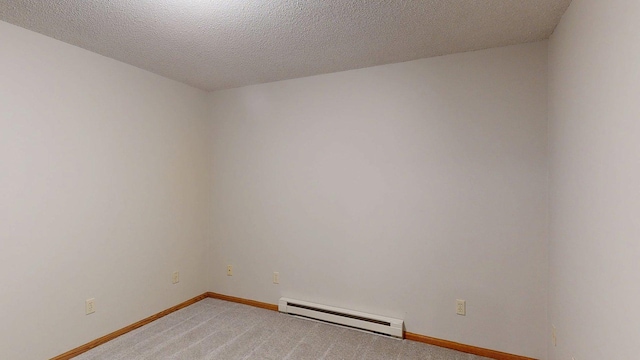 5121 Cameron Dr NW, Cascade Twp, MN 55901 - unfurnished room featuring a baseboard heating unit, light colored carpet, baseboards, and a textured ceiling