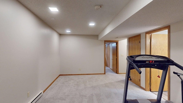 5121 Cameron Dr NW, Cascade Twp, MN 55901 - exercise area with light colored carpet, a baseboard radiator, baseboards, and a textured ceiling