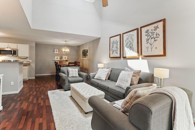 11219 16th St NE, Saint Michael, MN 55376 - living room with dark wood-style floors, a chandelier, baseboards, ceiling fan, and a towering ceiling
