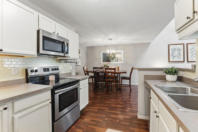 11219 16th St NE, Saint Michael, MN 55376 - kitchen with appliances with stainless steel finishes, a sink, backsplash, dark wood-style floors, and a textured ceiling