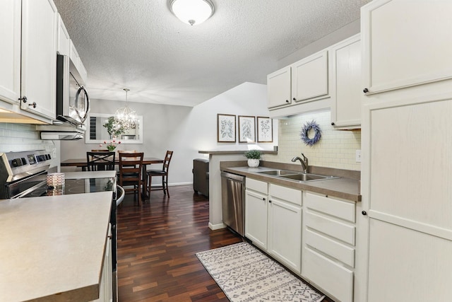 11219 16th St NE, Saint Michael, MN 55376 - kitchen with a sink, stainless steel appliances, backsplash, dark wood finished floors, and a textured ceiling