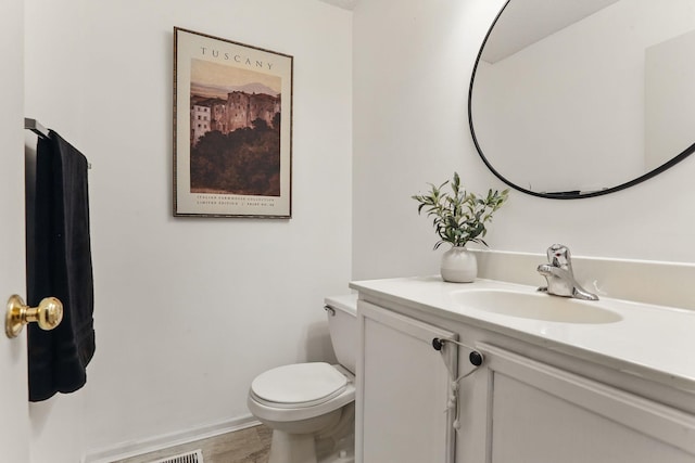 11219 16th St NE, Saint Michael, MN 55376 - bathroom featuring vanity, toilet, wood finished floors, and baseboards
