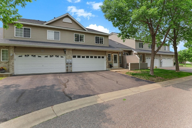 11219 16th St NE, Saint Michael, MN 55376 - view of property with driveway, a garage, and roof with shingles