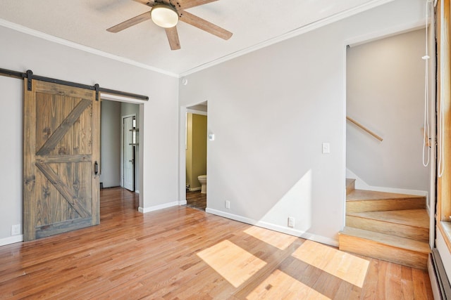 491 Belvidere St E, Saint Paul, MN 55107 - unfurnished bedroom featuring ornamental molding, light wood finished floors, baseboards, baseboard heating, and a barn door