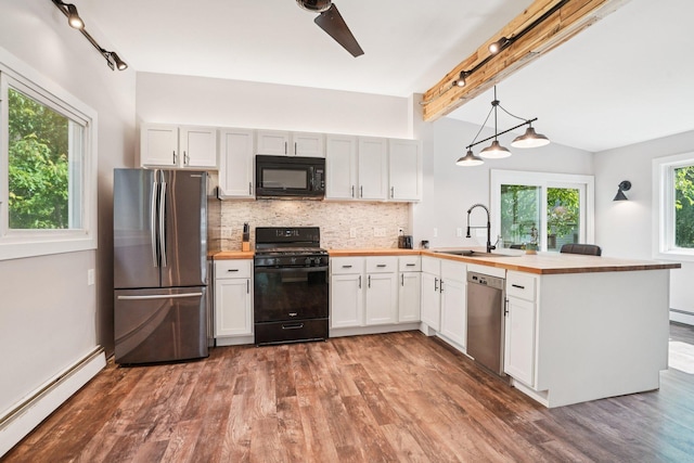 491 Belvidere St E, Saint Paul, MN 55107 - kitchen featuring black appliances, a baseboard heating unit, butcher block counters, a peninsula, and a sink