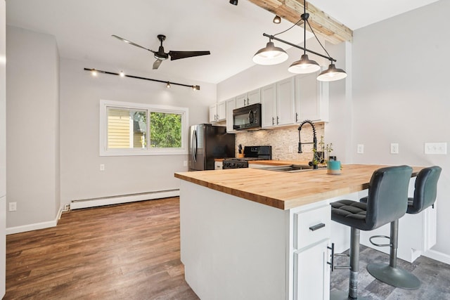 491 Belvidere St E, Saint Paul, MN 55107 - kitchen featuring baseboard heating, black appliances, a sink, wooden counters, and decorative backsplash
