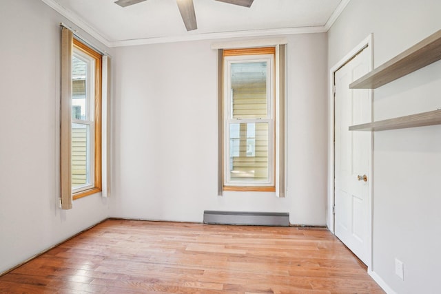 491 Belvidere St E, Saint Paul, MN 55107 - unfurnished bedroom featuring a baseboard heating unit, ornamental molding, light wood-style floors, and a ceiling fan