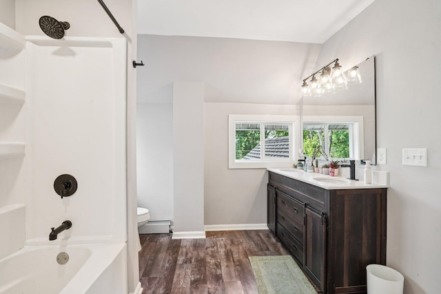 491 Belvidere St E, Saint Paul, MN 55107 - bathroom featuring double vanity, baseboard heating, wood finished floors,  shower combination, and toilet
