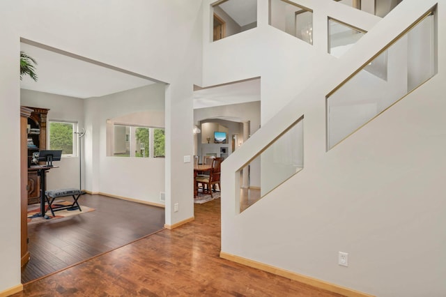 6242 Cavendish Pl, Eden Prairie, MN 55346 - entrance foyer with wood finished floors, arched walkways, and a towering ceiling
