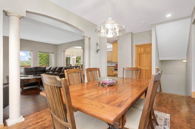 6242 Cavendish Pl, Eden Prairie, MN 55346 - dining space with arched walkways, decorative columns, light wood-style floors, a chandelier, and recessed lighting