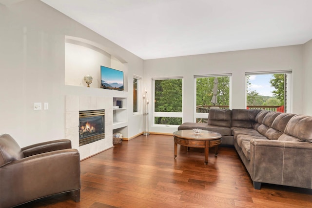 6242 Cavendish Pl, Eden Prairie, MN 55346 - living room with a tiled fireplace, wood finished floors, and built in shelves