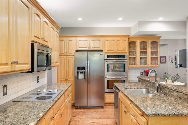 6242 Cavendish Pl, Eden Prairie, MN 55346 - kitchen featuring stainless steel appliances, light brown cabinets, light wood-style floors, glass insert cabinets, and decorative backsplash