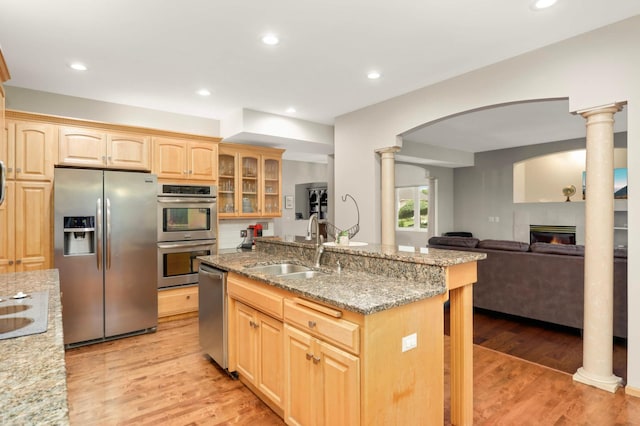 6242 Cavendish Pl, Eden Prairie, MN 55346 - kitchen featuring appliances with stainless steel finishes, light brown cabinetry, decorative columns, light stone countertops, and recessed lighting