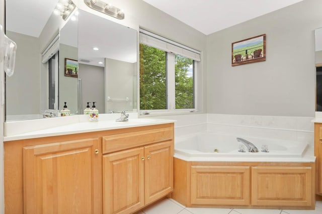 6242 Cavendish Pl, Eden Prairie, MN 55346 - bathroom with vanity, a jetted tub, and tile patterned flooring