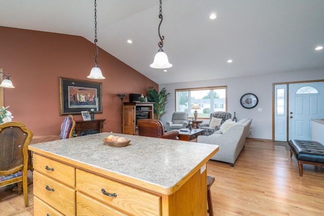 1022 Wilson Ave, Crookston, MN 56716 - kitchen with lofted ceiling, light countertops, a center island, light wood-style flooring, and recessed lighting