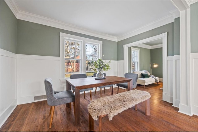 712 Anderson St W, Stillwater, MN 55082 - dining space featuring a decorative wall, plenty of natural light, wainscoting, wood finished floors, and crown molding