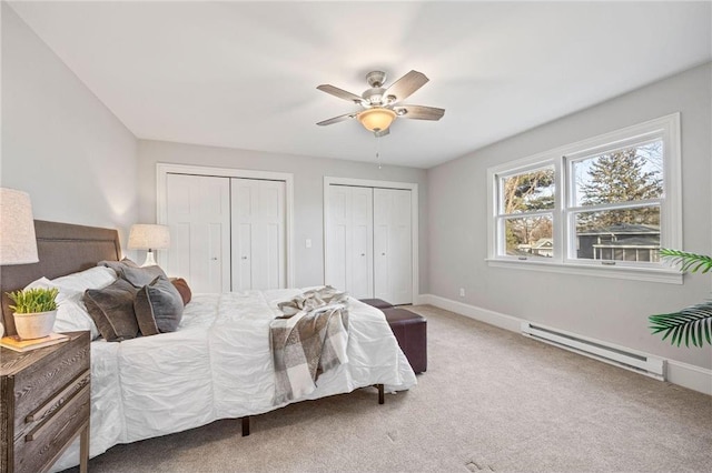 712 Anderson St W, Stillwater, MN 55082 - carpeted bedroom with a baseboard radiator, multiple closets, baseboards, and a ceiling fan