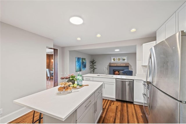 712 Anderson St W, Stillwater, MN 55082 - kitchen featuring stainless steel appliances, a sink, light countertops, dark wood-type flooring, and recessed lighting