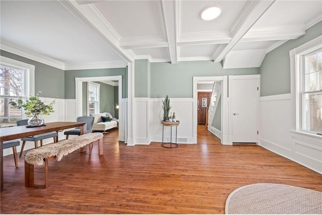 712 Anderson St W, Stillwater, MN 55082 - dining area with healthy amount of natural light, a decorative wall, wood finished floors, ornamental molding, and wainscoting