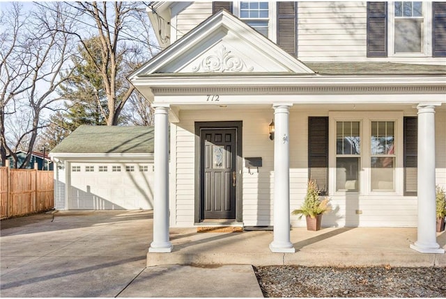 712 Anderson St W, Stillwater, MN 55082 - property entrance with covered porch, a garage, and concrete driveway