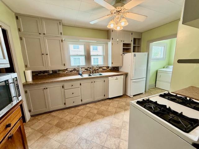 105 Oak St N, Mabel, MN 55954 - kitchen featuring white appliances, a sink, washer / dryer, and healthy amount of natural light