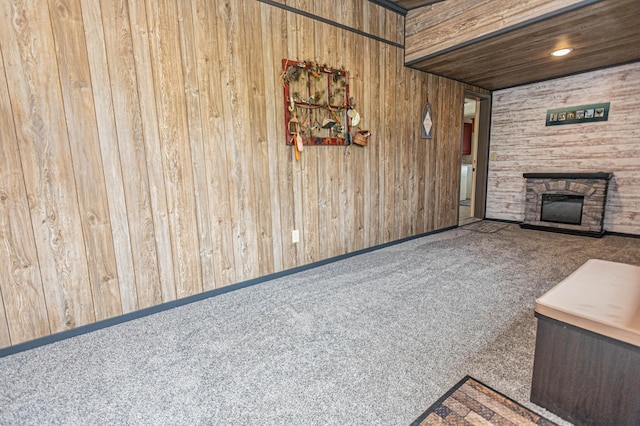 17366 Ryan Dr NE, Osakis, MN 56360 - unfurnished living room with carpet flooring, wood walls, and a stone fireplace