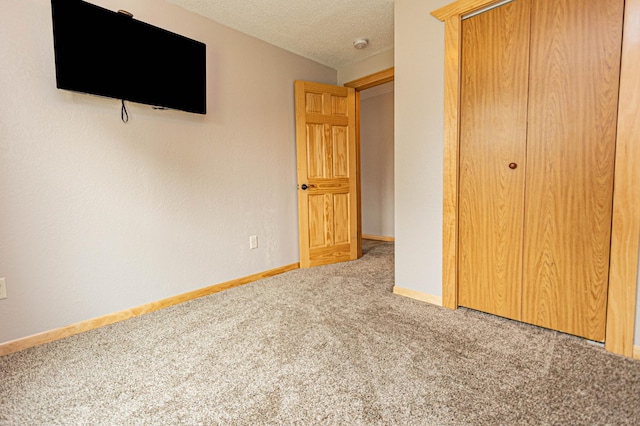 17366 Ryan Dr NE, Osakis, MN 56360 - unfurnished bedroom with carpet floors, a closet, baseboards, and a textured ceiling